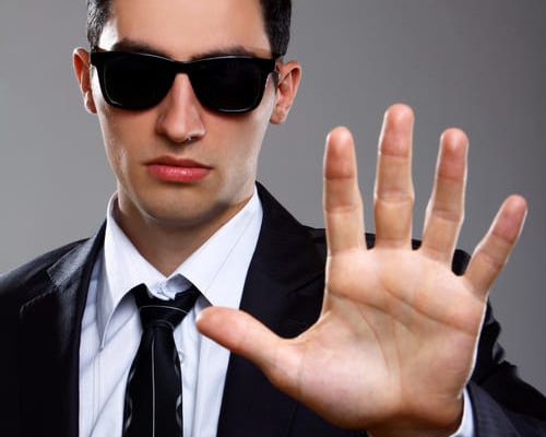 serious-man-suit-shows-stop-sign serious-man-suit-shows-stop-sign